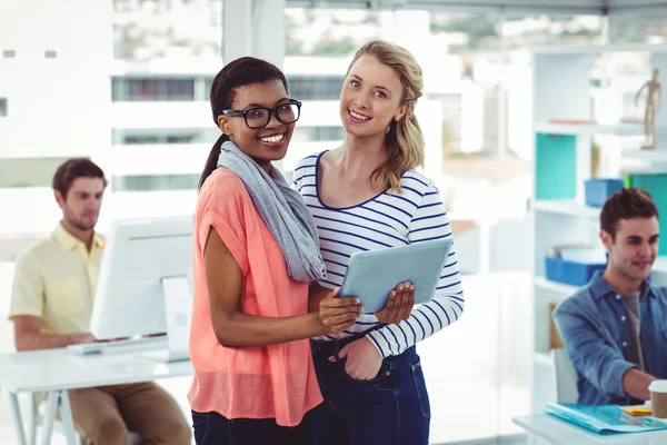 Happy creative team using a tablet pc — Stock Photo, Image