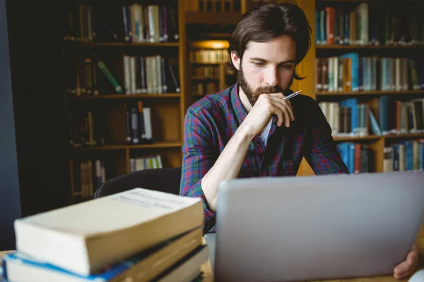 Hipster student studying in library — Stock Photo, Image