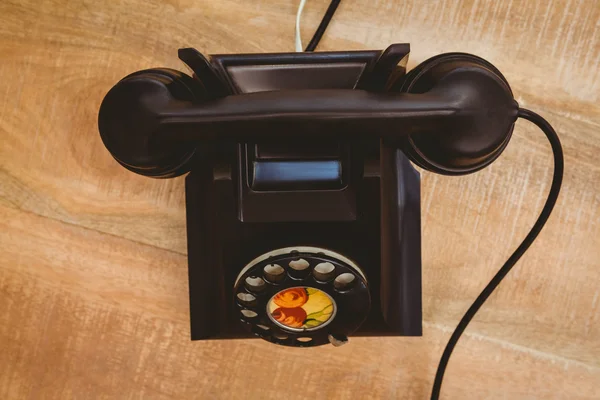 Old phone on wood desk — Stock Photo, Image