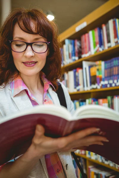 Mature student in the library — Stock Photo, Image