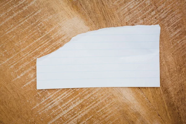 Piece of paper on wood desk — Stock Photo, Image