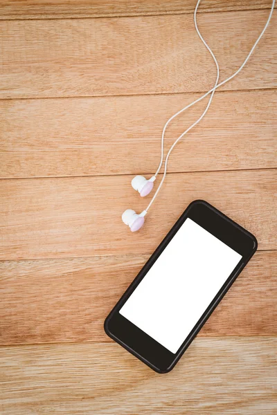 Smartphone preto com fones de ouvido brancos — Fotografia de Stock
