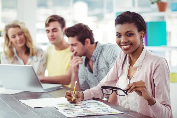 Creative business team working on a laptop together — Stock Photo, Image