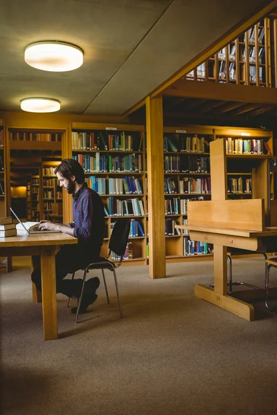 Hipster student studying in library — Stock Photo, Image