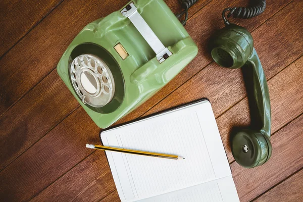 Old phone on wood desk — Stock Photo, Image