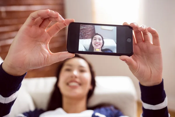 Asiatisk kvinna i soffan med selfie — Stockfoto
