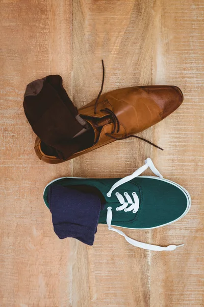 Two different shoes on wood plank — Stock Photo, Image