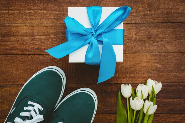 Sneakers and blue gift — Stock Photo, Image