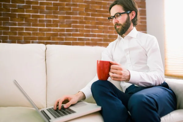 Homme d'affaires utilisant un ordinateur portable sur le canapé — Photo