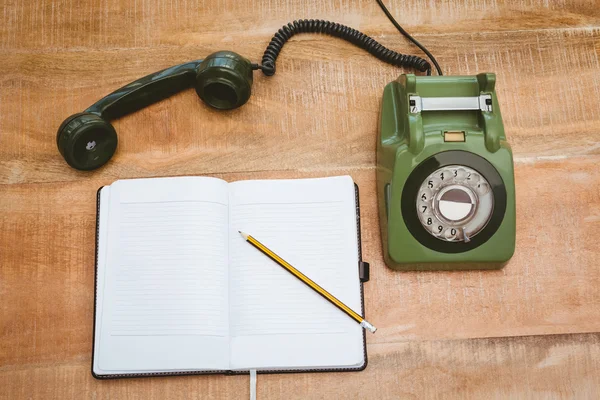 Old phone on wood desk — Stock Photo, Image