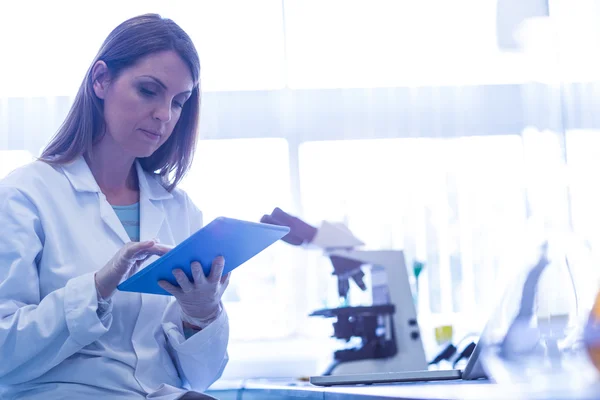 Scientist working with a tablet in laboratory — Stock Photo, Image