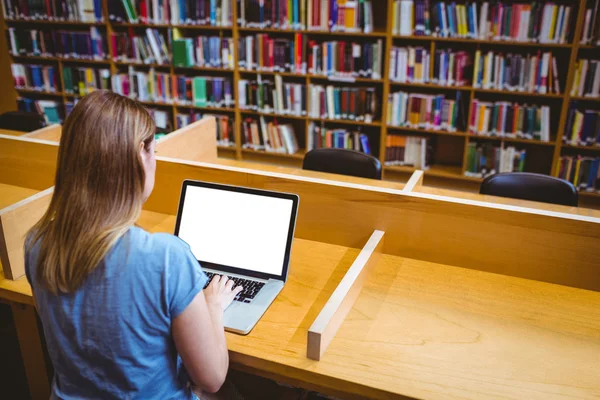 Volwassen student in de bibliotheek met behulp van laptop — Stockfoto