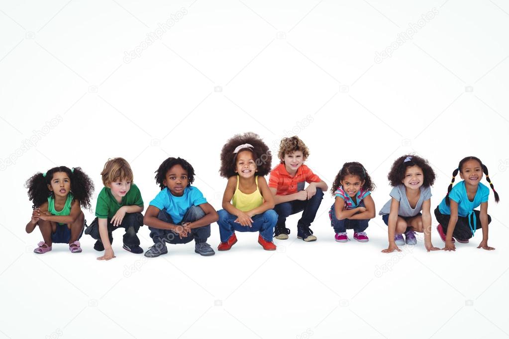 Fila de ninos agachados juntos Foto de stock 90541758 Wavebreakmedia