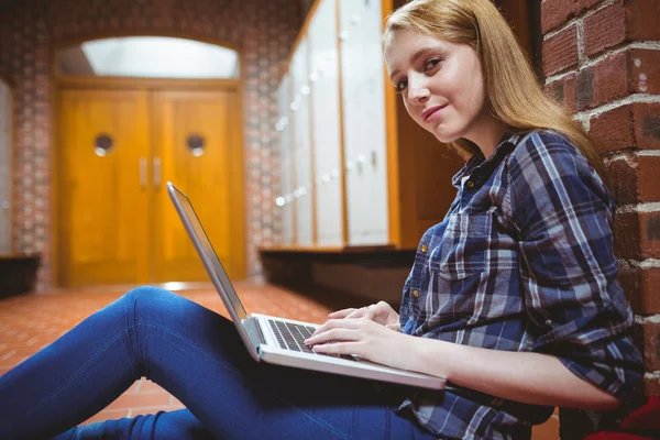 Smiling student using laptop and smartphone — Stock Photo, Image
