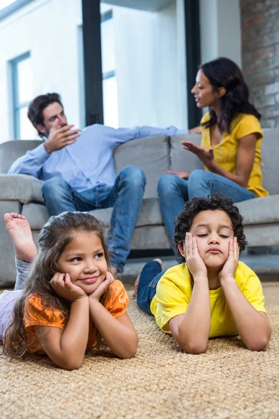 Children laying on the carpet in living room — Stock Photo, Image