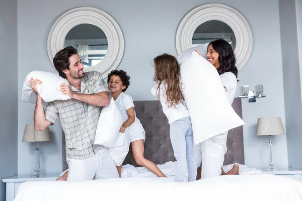 Happy family pillow fighting — Stock Photo, Image