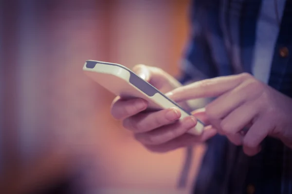 Standing student using smartphone — Stock Photo, Image