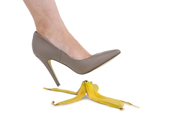 Cropped image of businesswoman crushing banana skin — Stock Photo, Image