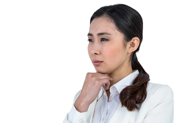 Focused businesswoman with hand on chin — Stock Photo, Image