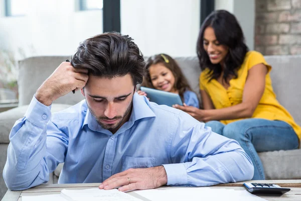 Thoughtful father paying bills in living room — Stock Photo, Image