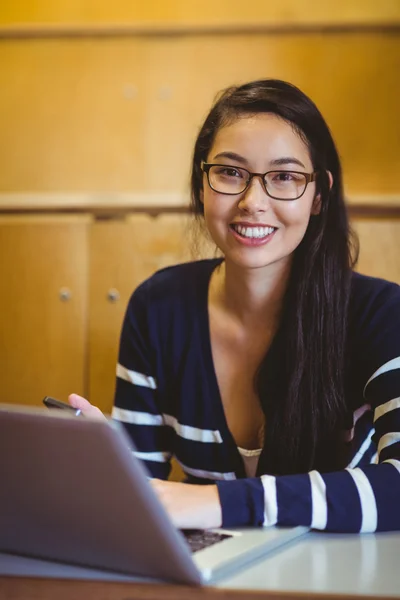 Studente sorridente utilizzando laptop e smartphone — Foto Stock