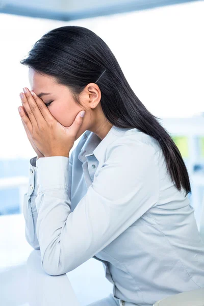 Worried businesswoman covering face — Stock Photo, Image