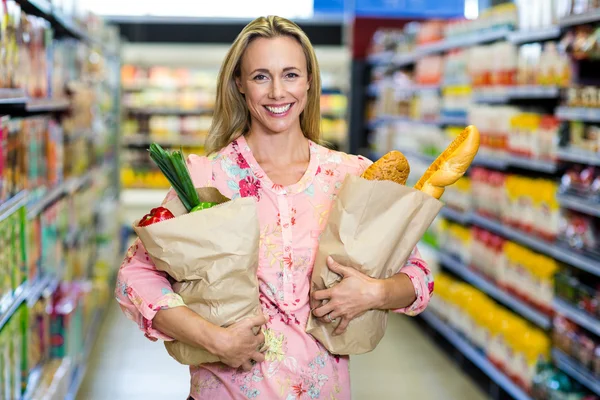 Beautiful woman standing with bags — Stock Photo, Image