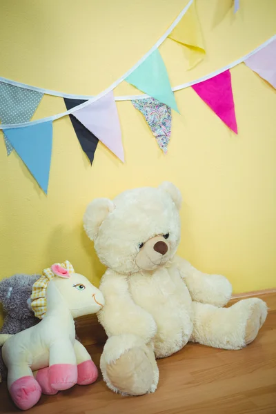 Decorations and fluffy teddies against the wall — Stock Photo, Image