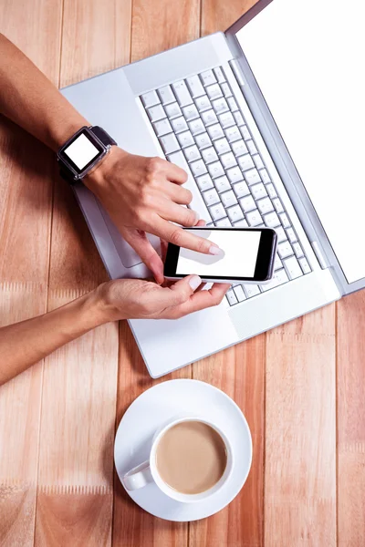 Woman with smartwatch using smartphone — Stock Photo, Image