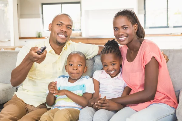 Retrato de uma família de quatro assistindo tv — Fotografia de Stock