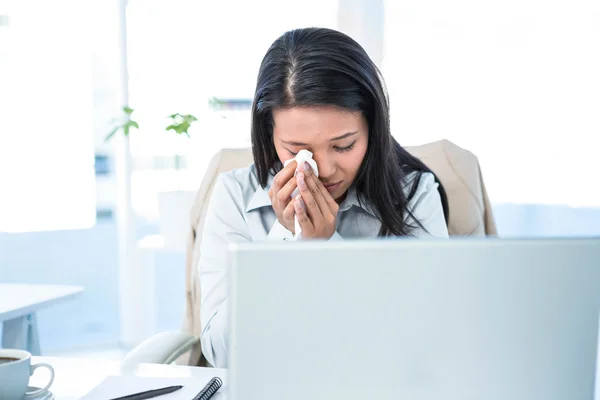 Sad businesswoman wiping her tears — Stock Photo, Image