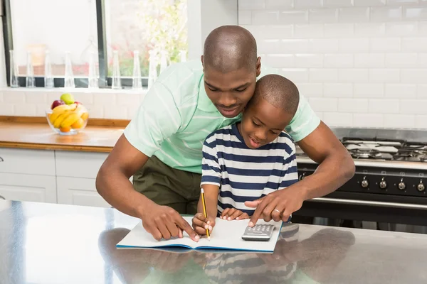 Père aidant son fils avec les devoirs — Photo