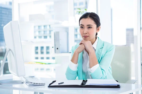 Smiling creative businesswoman by her desk — Stock Photo, Image