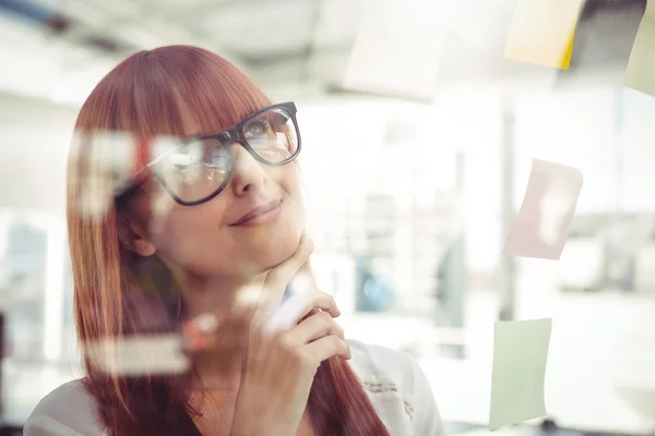 Attractive hipster woman looking at sticky notes — Stock Photo, Image