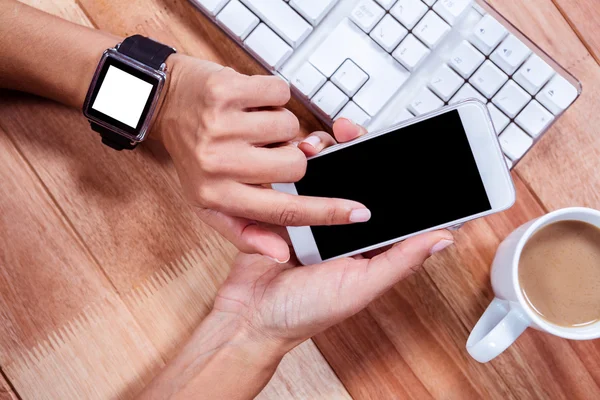 Feminine hands with smartwatch using smartphone — Stock Photo, Image