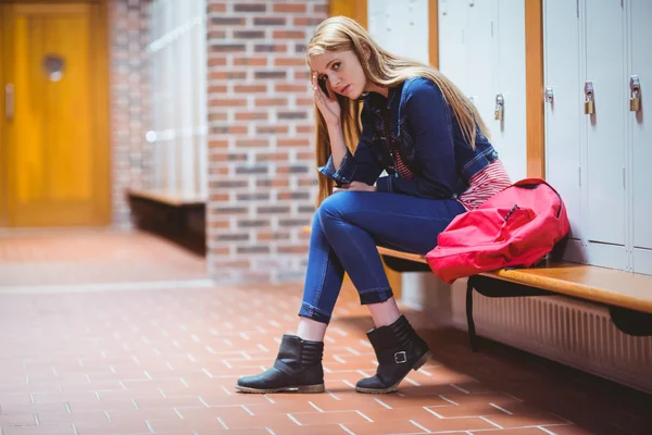 Worried student sitting in locker room — Stock Photo, Image