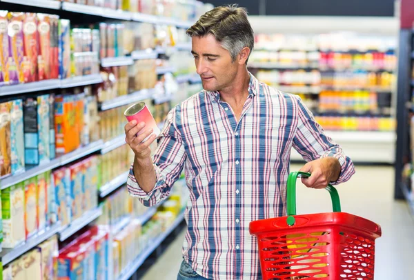 Man reading nutritional values Stock Image