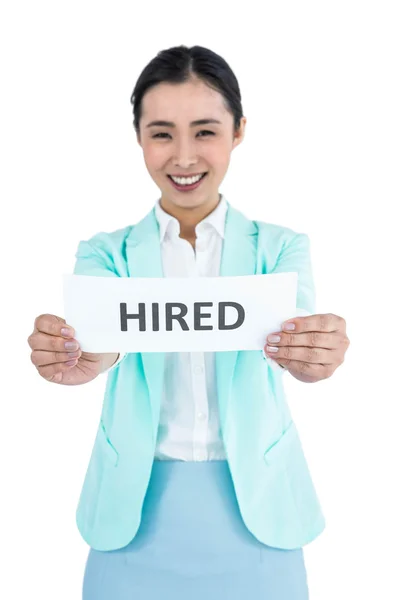 Businesswoman holding a signboard hired — Stock Photo, Image