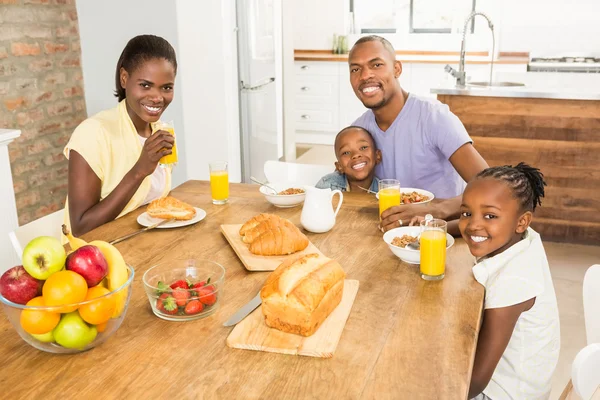 Casual happy family having breakfast — Stock Photo, Image