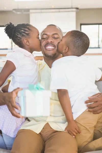 Happy father is kissed by his two children — Stock Photo, Image