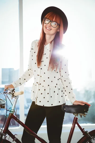 Smiling hipster woman with her bicycle — Stock Photo, Image
