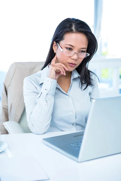 Serious businesswoman using laptop — Stock Photo, Image