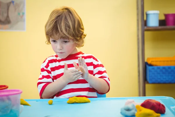 Happy boy holding modelling clay — Stock Photo, Image