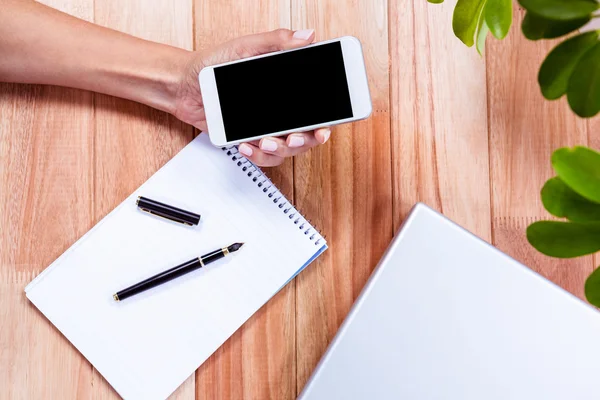 Overhead of feminine hands holding smartphone — Stock Photo, Image