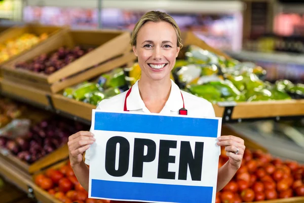 Smiling woman holding sign — Stock Photo, Image