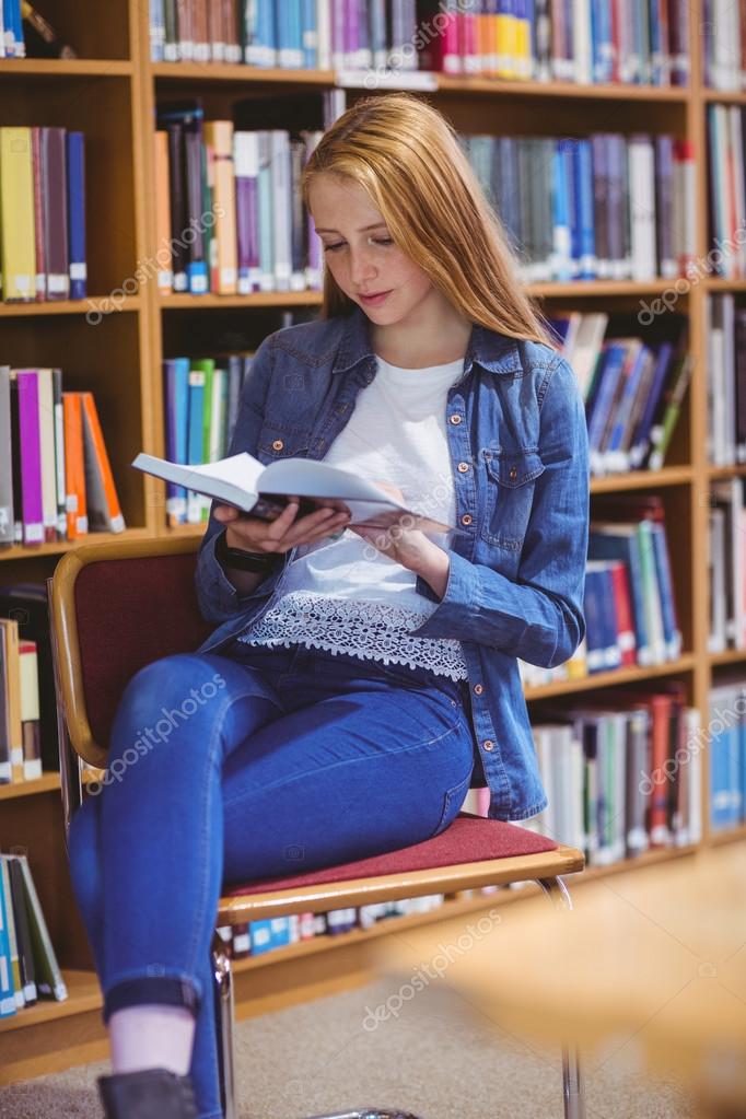 Pretty student sitting on chair Stock Photo by ©Wavebreakmedia 90560028