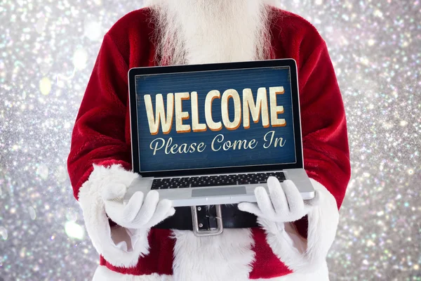 Santa Claus presenterar en laptop — Stockfoto