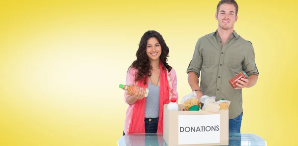 Smiling volunteers taking out food — Stock Photo, Image