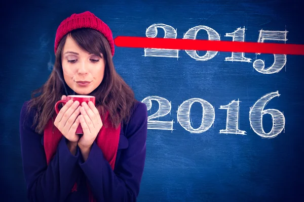 Festive brunette holding a mug — Stock Photo, Image