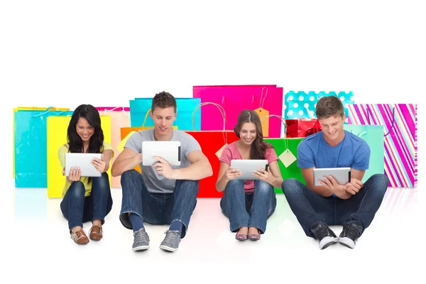 Friends sitting on ground with tablets — Stock Photo, Image